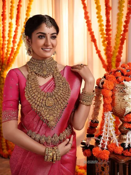 Another angle from the Rajakumari Gold shoot, showing how the makeup looks from the side. The carefully braided hair adorned with jasmine and the perfectly placed maang tikka are key elements of this classic South Indian bridal hairstyle.