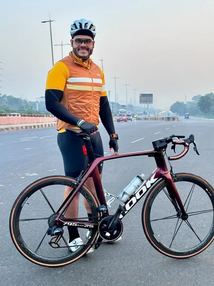 A rider proudly posing with his LOOK road bike, ready to take on the miles.