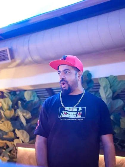 A candid shot of me on the decks, with the lush greenery of Pangeo in the background.