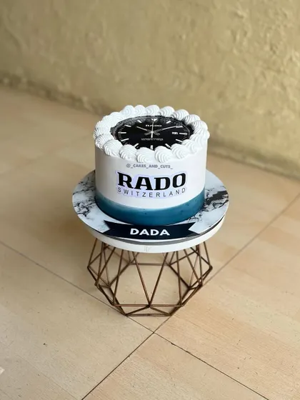 A cake designed for a watch enthusiast, featuring the Rado brand logo and a watch face. This is a great example of a personalized cake for an adult.