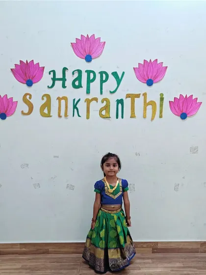 This little girl looks wonderful in her green and gold pavadai, celebrating the harvest festival with us.
