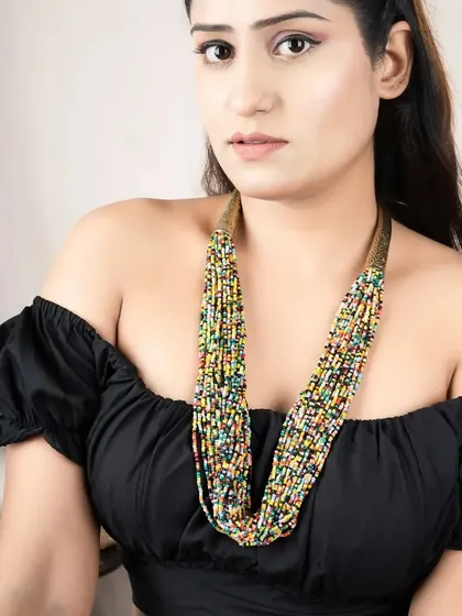 A lifestyle shot of a model wearing a multi-strand beaded necklace. This shows the scale and styling of the accessory.