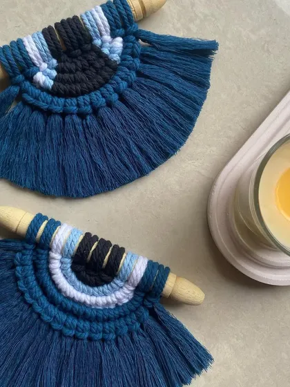 Our evil eye wall hangings look great paired with other decor, like a scented candle. They are small enough to fit in any space, from your office to your car.