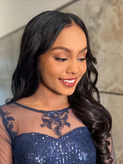 A close-up of the soft, open hairstyle, showing the healthy shine and gentle waves.