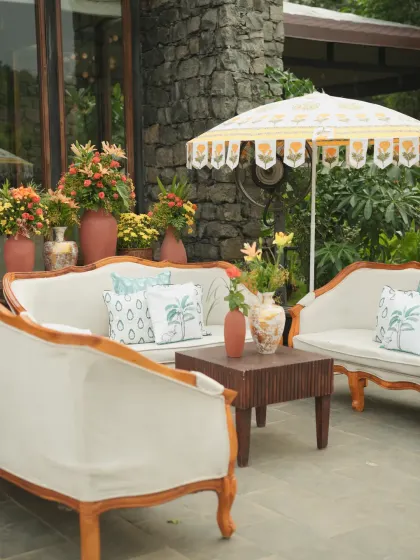 A wider view of the serene Haldi lounge area, designed to be a comfortable and beautiful space for guests to relax and mingle.