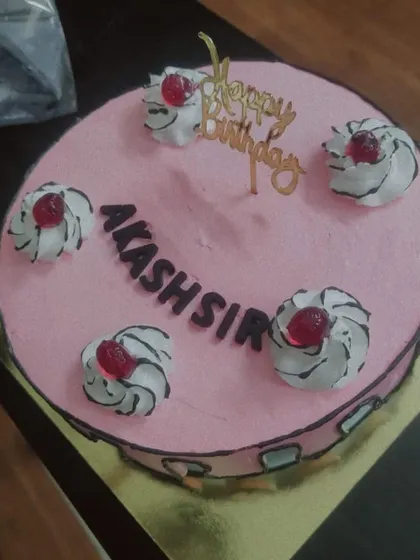 A fun take on a classic cake, this design has a comic book-style outline. The pink frosting and simple piped swirls make it a playful choice for any birthday.
