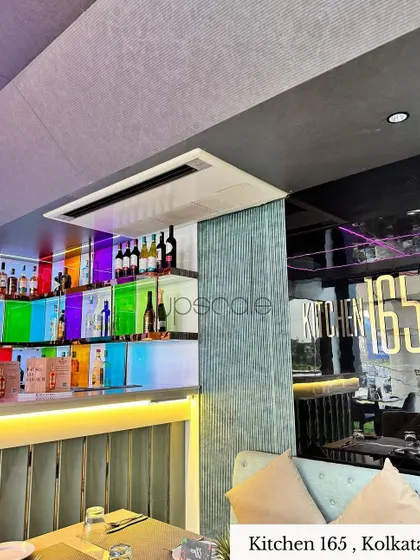 At Kitchen 165 in Kolkata, the bar corner is a fusion of vibrancy and sophistication. We used metallic powder teal wall panels and playful colored glass accents, balanced by elegant teal grey sofas, to create a mood that is both jazzy and subtle.
