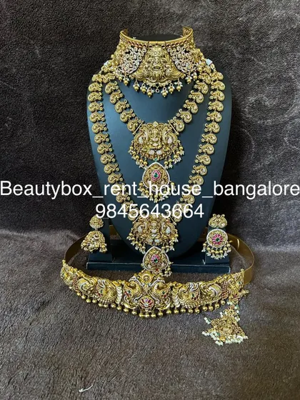 A majestic temple jewellery set featuring two large Lakshmi pendants on the choker and haaram. This rental includes a matching vaddanam.