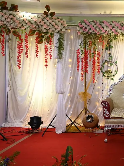 Another shot of the stage with hanging pink and red florals.