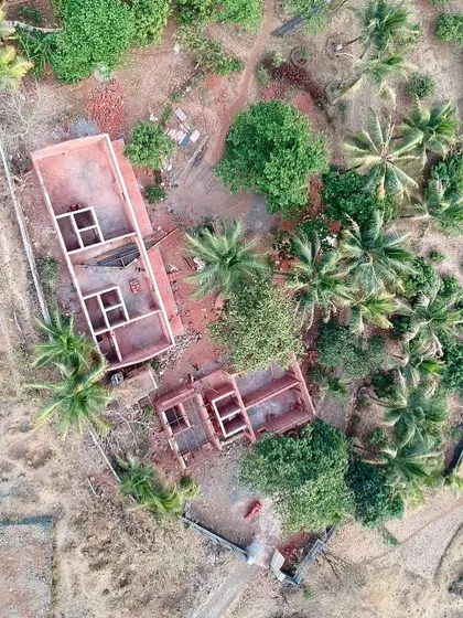 A later drone shot of Organic Square during construction. Here you can see the walls rising and the deconstructed plan taking form amidst the tropical paradise.