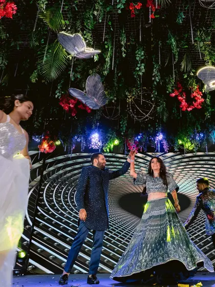 The couple's dance performance at their Sangeet. The stage backdrop and overhead greenery created a stunning visual.
