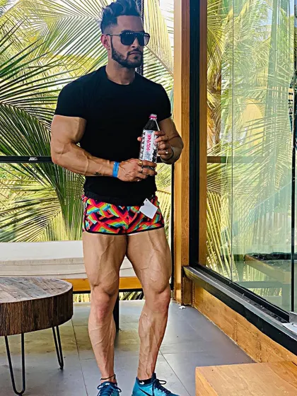 Strong legs are the foundation of a powerful physique. This shot highlights the quad separation and vascularity that can only be built through intense leg day workouts.