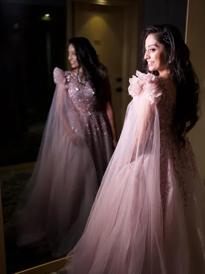 A fairytale moment for this reception bride. The soft, dewy makeup and elegant hairstyle were designed to complement her dreamy pastel gown, creating a look of pure, ethereal elegance.