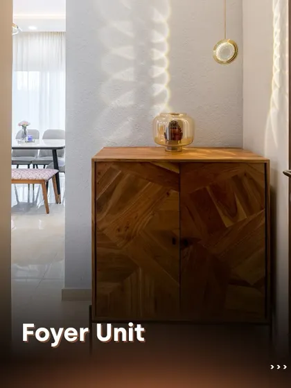 This minimalist foyer unit features a stunning wood cabinet with a geometric parquet pattern. The simple design is elevated by a single pendant light, creating beautiful light and shadow play.
