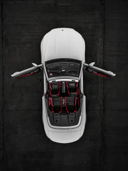 A top-down drone shot of a convertible Mercedes, focusing on the clean lines and bold interior. This demonstrates a different, more commercial style of aerial photography.