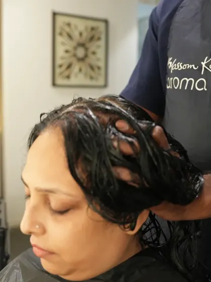 A close-up of the care I put into every hair spa. Massaging the treatment into the hair ensures every strand is coated, resulting in unparalleled softness and shine.