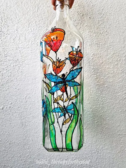 A different view of the garden-themed bottle, highlighting the delicate dragonflies and orange flowers. This piece was a custom order that I sent all the way to Singapore.