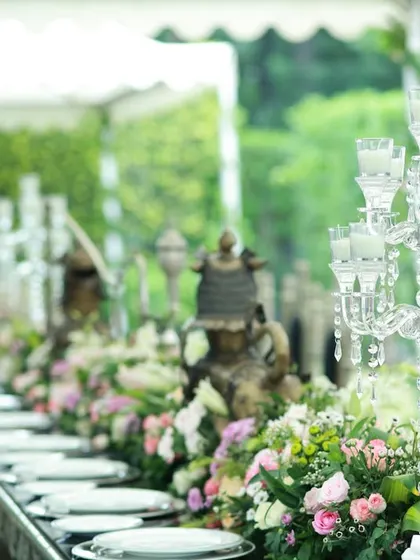 A royal, heritage-themed tablescape with ornate silver chairs and crystal candelabras. This setup was for a grand event celebrating Indian royalty, and the decor reflects that opulent and authentic spirit.