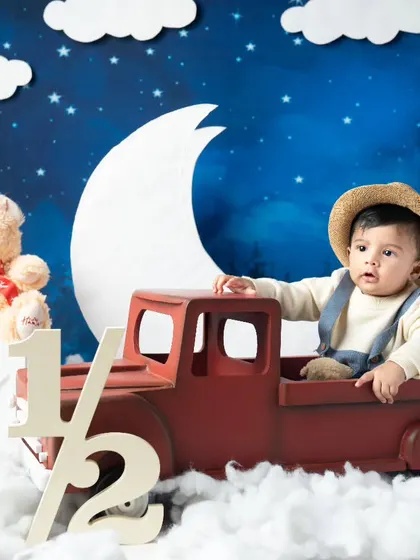 Driving into the second half of his first year. This half-birthday shoot with a red truck and night-sky theme is so creative.