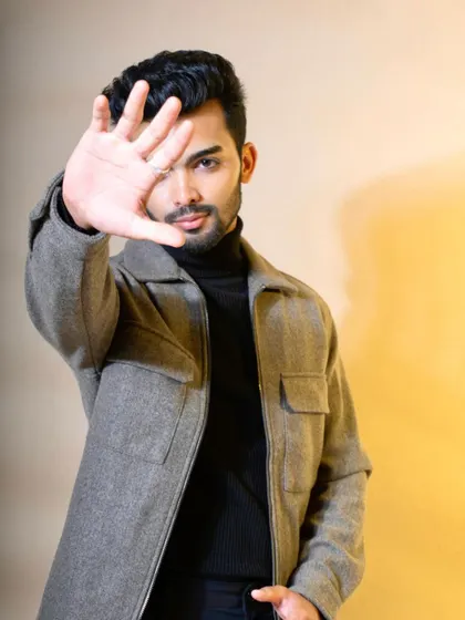 This image captures a modern, casual look with a strong attitude. The combination of a felt jacket over a turtleneck is a versatile style, and the direct pose makes it a compelling shot for personal branding or a commercial modeling portfolio.