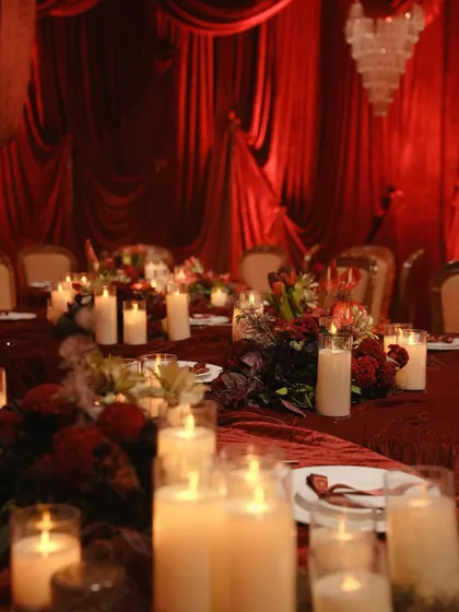 The warm glow of candlelight reflecting on the red velvet tablecloth. This shot captures the intimate and romantic ambiance we strive to create for special dinners.