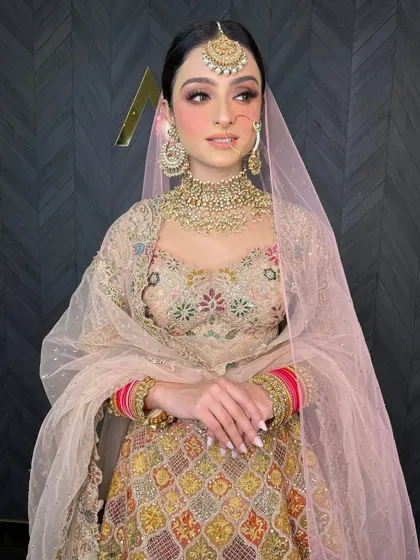 This bride looks like a dream in a pastel lehenga and a classic polki choker set.