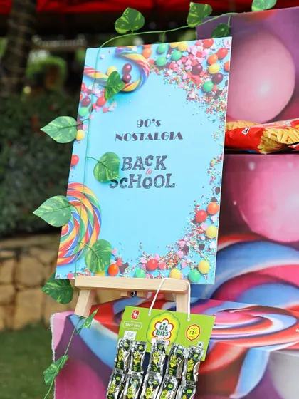 A welcome sign for the 90s themed candy station, adding a playful and personal touch to the event.