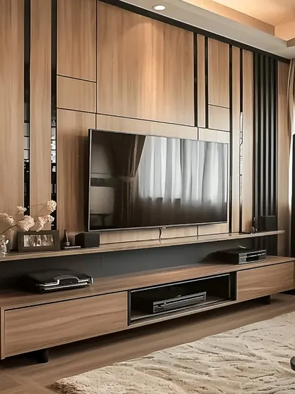 We designed this full-wall TV unit with a mix of wood and black accents for a sleek, modern look. The paneling adds texture and depth, while the ample storage keeps the living area organized.