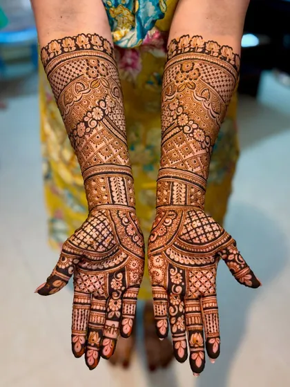 A top-down view of the detailed bridal mehendi, showing the symmetry and complexity.