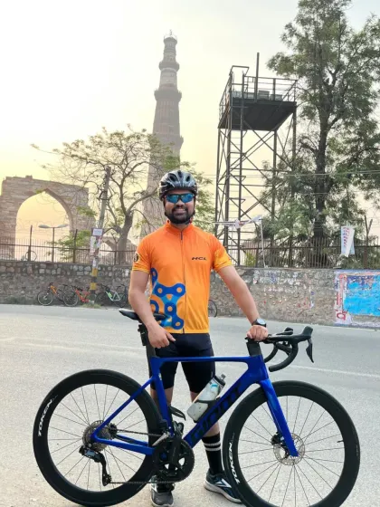 A rider and his high-performance bike against the historic backdrop of Qutub Minar. A perfect blend of modern passion and ancient beauty.