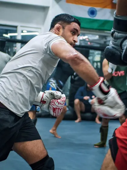 A focused shot of a fighter throwing a punch during a sparring session. This is where technique is tested under pressure.