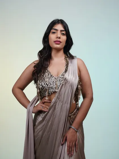 This metallic saree is all about the statement blouse. The intricate, scale-like sequin work on the blouse is a showstopper, perfect for when you want all eyes on you.