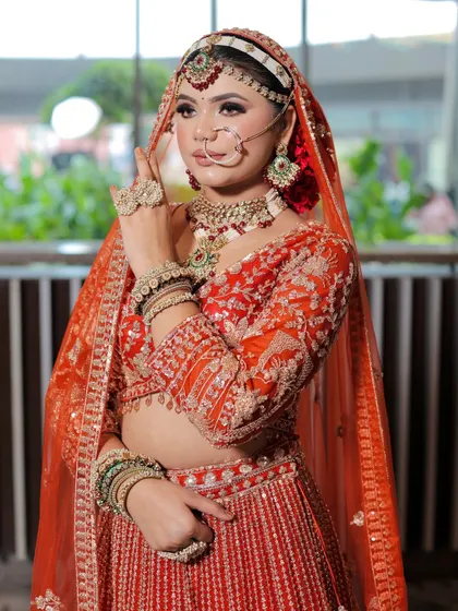A side profile showing the flawless blending of the makeup and the neatness of the hairstyle. Every detail is taken care of.