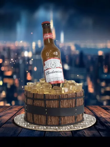 A cake for the person who loves a cold one. This design features a Budweiser bottle chilling in a bucket of edible ice cubes.