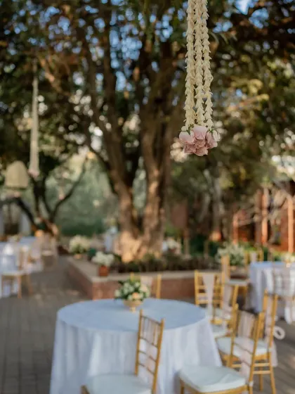 A dreamy shot of the outdoor engagement venue, with hanging florals and elegant table settings.