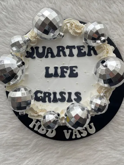 A "Quarter Life Crisis" cake is a fun and relatable theme for anyone in their mid-twenties. The disco balls add a touch of humor and sparkle.