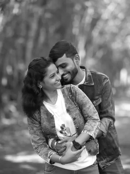 A timeless black and white pre-wedding portrait of a couple in a warm and happy embrace, highlighting their emotional connection.