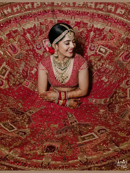 A bride's portrait is more than a photo; it's a timeless piece of art. Here, we captured Kriti in her magnificent red lehenga, showcasing the intricate details of her attire and the joyful anticipation in her smile.