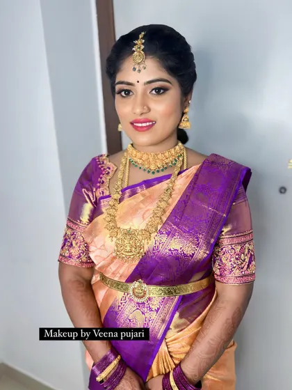A smiling portrait of Sahana Gowda. She looks absolutely radiant celebrating this special family moment.