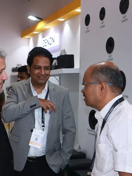 Our team members discussing our KEF and Definitive Technology architectural speakers with attendees. Our demo rooms and thoughtfully designed stalls allow for hands-on experiences.