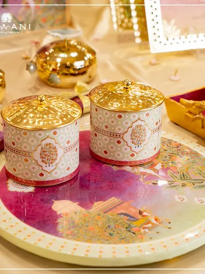 A closer view of the artisanal jars and tray from a personalized wedding collection. The intricate patterns and rich colors are designed to complement the overall theme, making even the smallest details feel luxurious.