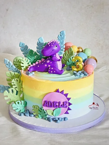 A rainbow dinosaur cake! The birthday girl wanted a purple dino and a rainbow, so I combined them for this colorful and fun design.