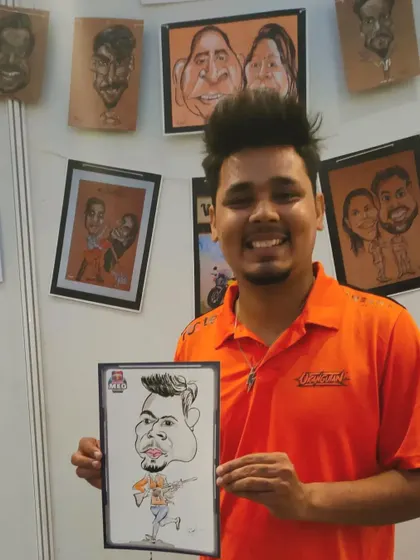 A smiling gamer from the Godlike esports team with his caricature souvenir.
