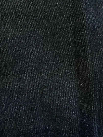 A swatch of pure black, non-stretch denim. This is a versatile choice for creating sleek custom jeans, jackets, or even trousers.