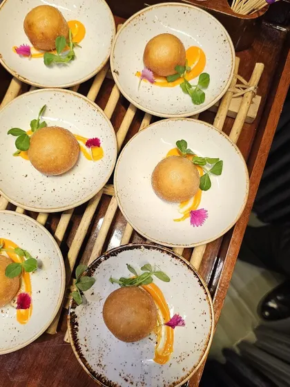 A close-up of our individually plated spherical appetizers, garnished with microgreens.