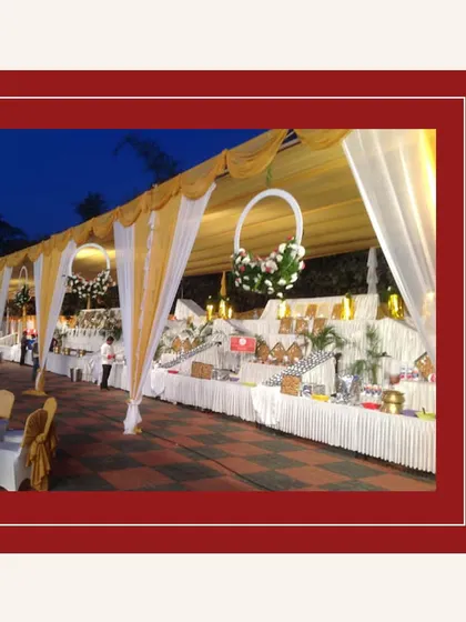 An outdoor evening buffet setup under a beautifully decorated canopy. We can create a magical dining experience in any setting.
