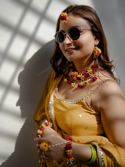 A close-up of the stylish Haldi bride, Nidhi. The play of light and shadow adds depth and character to this beautiful photograph.