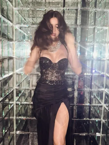 A playful shot from the same event. Even with movement, the hair and makeup remain flawless, showcasing a look that's perfect for a night of celebration.