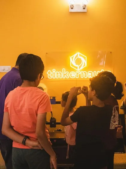The "Tinkernauts" sign in our workshop space is a beacon for curious minds. Students often gather here, full of questions and ideas, ready to dive into the next challenge.