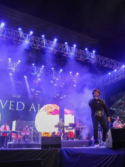 Javed Ali on stage at JGU, with a large LED screen backdrop and professional trussing, all part of our end-to-end production services.